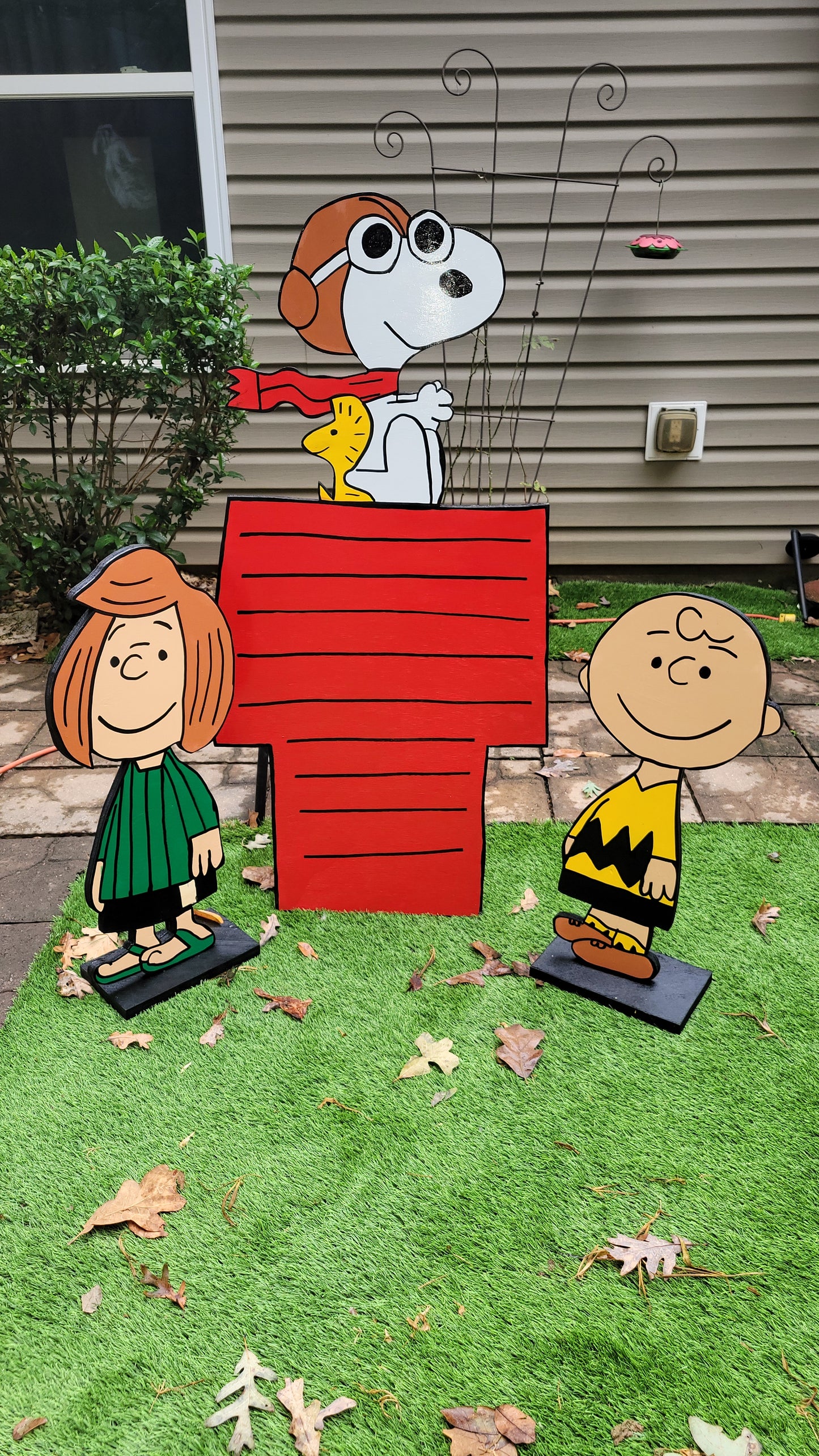 Charlie Brown and Peppermint Patty with Flying ace Snoopy on doghouse