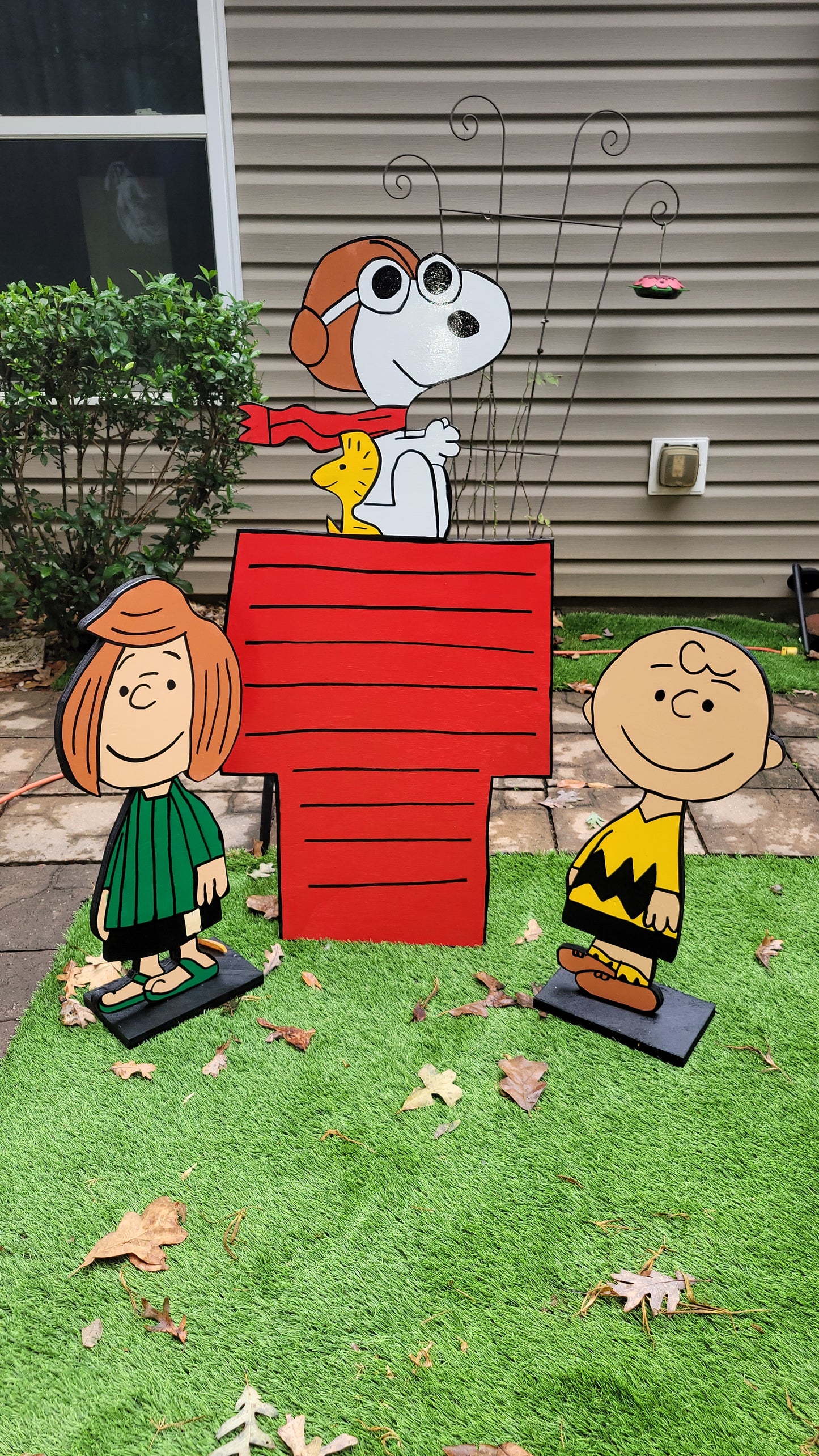 Charlie Brown and Peppermint Patty with Flying ace Snoopy on doghouse