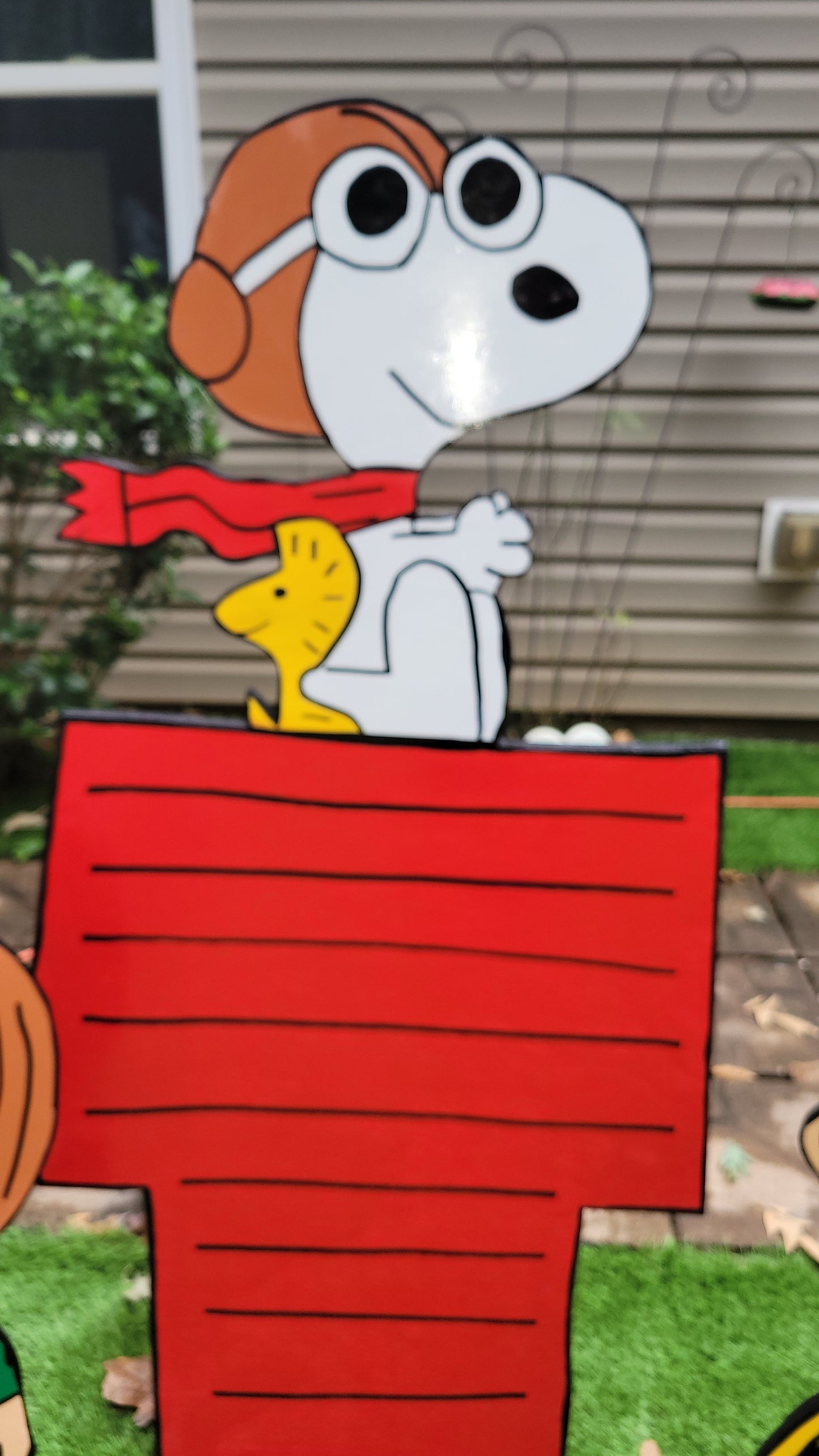 Charlie Brown and Peppermint Patty with Flying ace Snoopy on doghouse