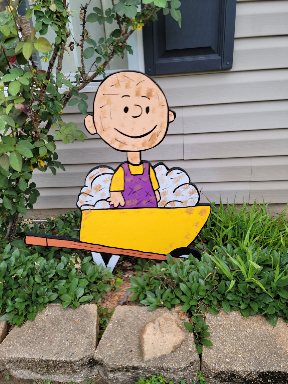 Pigpen in wheelbarrow yard art