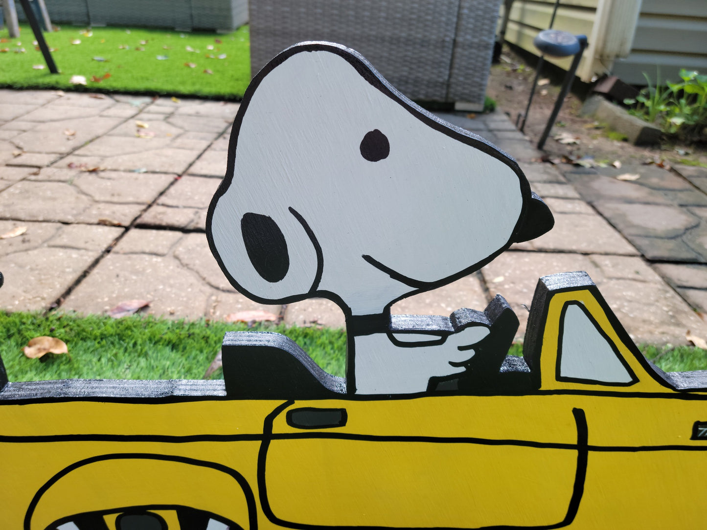 Snoopy driving 1955 thunderbird car. Yard art.