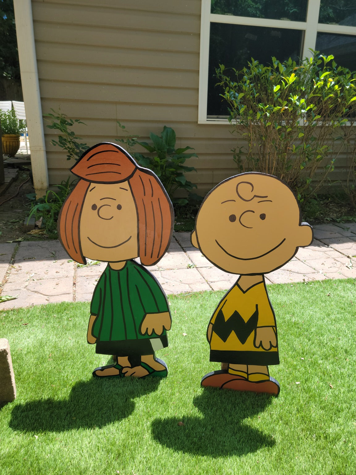 Charlie Brown and Peppermint Patty yard art