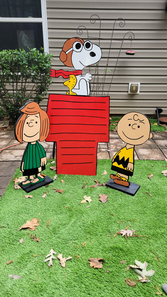 Charlie Brown and Peppermint Patty with Flying ace Snoopy on doghouse